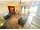 Large living room with wood floors, a ceiling fan, furniture, and sliding doors leading to the porch at 2172 University S Dr, Clearwater, FL 33764