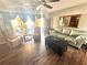 Bright living room with wood floors, a ceiling fan, sliding glass doors to the porch, and comfortable seating at 2172 University S Dr, Clearwater, FL 33764