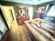 Green bedroom with a queen size bed, hardwood floors, and dresser at 2172 University S Dr, Clearwater, FL 33764