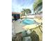 Well-maintained pool surrounded by a concrete deck and lush green grass at 2172 University S Dr, Clearwater, FL 33764