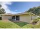 An exterior image reveals a backyard with a stucco home, covered patio, and lawn at 2333 Appaloosa Cir, Sarasota, FL 34240