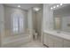 Well-lit bathroom featuring a garden tub under an arched window, along with a vanity and a shower at 2333 Appaloosa Cir, Sarasota, FL 34240