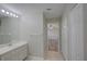 Functional bathroom with a well-lit vanity, closet space, and doorways leading to additional rooms at 2333 Appaloosa Cir, Sarasota, FL 34240