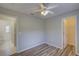 Bedroom featuring wood floors, a ceiling fan, and closet access at 2333 Appaloosa Cir, Sarasota, FL 34240