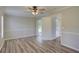 Cozy bedroom with wood-look floors and a ceiling fan, leading to other rooms and offering outdoor access at 2333 Appaloosa Cir, Sarasota, FL 34240