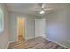 Bedroom featuring wood floors, a closet, and a ceiling fan at 2333 Appaloosa Cir, Sarasota, FL 34240