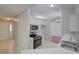 Open kitchen layout with tile floor, white cabinets, modern oven, and view into the dining area and front entry at 2333 Appaloosa Cir, Sarasota, FL 34240