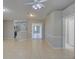 Spacious living room with tile flooring, ceiling fan, and a view into the kitchen and patio area at 2333 Appaloosa Cir, Sarasota, FL 34240