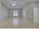 Bright, open living room featuring tile flooring, natural light, and a modern ceiling fan at 2333 Appaloosa Cir, Sarasota, FL 34240