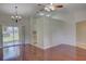 Open living room with hardwood floors, ceiling fan, and sliding glass doors to a patio at 2333 Appaloosa Cir, Sarasota, FL 34240