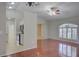 Living room with hardwood floors, ceiling fan, and view into the kitchen at 2333 Appaloosa Cir, Sarasota, FL 34240