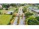 An aerial view displaying the manicured entrance, lush landscaping, and community gate at 2609 Locksley St, Sun City Center, FL 33573