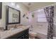 Bathroom featuring a modern vanity with granite counters, and a shower and tub at 2609 Locksley St, Sun City Center, FL 33573