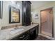 Updated bathroom featuring a vanity with granite countertops and a glass-enclosed shower stall at 2609 Locksley St, Sun City Center, FL 33573