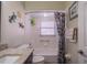 Cozy bathroom featuring granite vanity top, toilet, and tub with shower and patterned curtain at 2609 Locksley St, Sun City Center, FL 33573