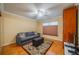 Bright, carpeted room featuring a gray sofa bed, area rug, and a window at 2609 Locksley St, Sun City Center, FL 33573