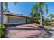 Charming home featuring a brick driveway, attached garage, and well-manicured landscaping at 2609 Locksley St, Sun City Center, FL 33573