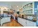 Well-lit kitchen featuring tile backsplash, stainless appliances, and an open view to the dining area at 2609 Locksley St, Sun City Center, FL 33573