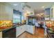 Well-appointed kitchen offering granite countertops, white cabinets, and a view into the adjacent dining space at 2609 Locksley St, Sun City Center, FL 33573