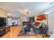 Inviting living room featuring hardwood floors, comfortable seating, and a view of the dining area at 2609 Locksley St, Sun City Center, FL 33573