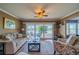 Comfortable living room with large sliding glass doors opening to a serene lake view at 2609 Locksley St, Sun City Center, FL 33573