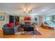 Comfortable living room showcasing hardwood floors, a plush sofa, and bright natural light at 2609 Locksley St, Sun City Center, FL 33573