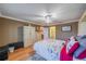 This charming bedroom showcases a ceiling fan, wood floors, and a cozy, inviting atmosphere at 2609 Locksley St, Sun City Center, FL 33573