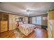 Spacious bedroom features wood flooring, a ceiling fan, and custom built-in closet storage at 2609 Locksley St, Sun City Center, FL 33573