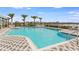 Community swimming pool surrounded by lounge chairs and palm trees at 2955 Rock Sound St, Bradenton, FL 34208