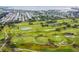 Aerial view of the golf course with water and residential area near the water at 3934 Doral Dr, Tampa, FL 33634