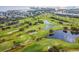 Aerial view of the golf course with water hazards, lush green fairways, and trees at 3934 Doral Dr, Tampa, FL 33634