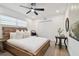 Cozy bedroom featuring a rustic wood bed frame, white bedding, and natural light at 3934 Doral Dr, Tampa, FL 33634