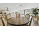 Dining room with a round wooden table, chairs, and a view to the open kitchen and living room at 3934 Doral Dr, Tampa, FL 33634