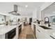 Modern kitchen featuring an island cooktop, stainless steel appliances, and white cabinetry at 3934 Doral Dr, Tampa, FL 33634