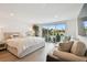 Spacious main bedroom with pool view, comfortable seating area, and modern furnishings at 3934 Doral Dr, Tampa, FL 33634