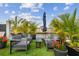 Relaxing outdoor seating area with palm trees, a canal view, and comfortable patio furniture at 3934 Doral Dr, Tampa, FL 33634