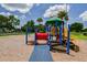 Brightly colored playground featuring slides, swings, climbing structures, and a soft landing surface at 3934 Doral Dr, Tampa, FL 33634