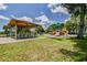 Playground area with picnic tables, shade structure, and assorted play equipment at 3934 Doral Dr, Tampa, FL 33634