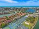 Stunning aerial view of the property highlighting the waterfront location and tennis courts at 440 Sandy Hook Rd, Treasure Island, FL 33706