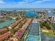 Aerial view of townhomes highlighting waterfront location, tennis courts, and community features at 440 Sandy Hook Rd, Treasure Island, FL 33706