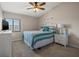 Cozy bedroom with natural light and a comfortable bed with blue accents at 440 Sandy Hook Rd, Treasure Island, FL 33706