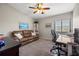 Bedroom featuring a comfortable couch, desk, and ample natural light, ideal for work or relaxation at 440 Sandy Hook Rd, Treasure Island, FL 33706