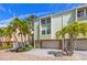 Charming townhome featuring a well-manicured yard, stone accents, and an attached garage at 440 Sandy Hook Rd, Treasure Island, FL 33706