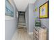 Inviting hallway with neutral paint, decorative accents, and a staircase leading to the upper level at 440 Sandy Hook Rd, Treasure Island, FL 33706