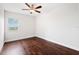 Bright bedroom features hardwood floors, a ceiling fan, and a window with natural light at 4516 Seagull Dr # 303, New Port Richey, FL 34652