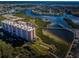 High-angle shot of a luxury condominium by the water, complemented by landscaped grounds and serene marina views at 4516 Seagull Dr # 405, New Port Richey, FL 34652