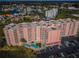 High-angle view shows the condominium, pool area, and extensive parking at 4516 Seagull Dr # 405, New Port Richey, FL 34652