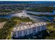 Elevated view shows the condominium's beautiful exterior, ample parking, and surrounding greenery at 4516 Seagull Dr # 405, New Port Richey, FL 34652