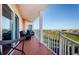 Spacious balcony with chairs and a table and a view of trees and blue skies at 4516 Seagull Dr # 405, New Port Richey, FL 34652