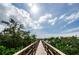 Scenic boardwalk surrounded by lush greenery and blue skies at 4516 Seagull Dr # 405, New Port Richey, FL 34652